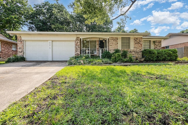2530 Robin Ln, Garland, TX 75041 - view of front of home with brick siding, a garage, driveway, and a front yard