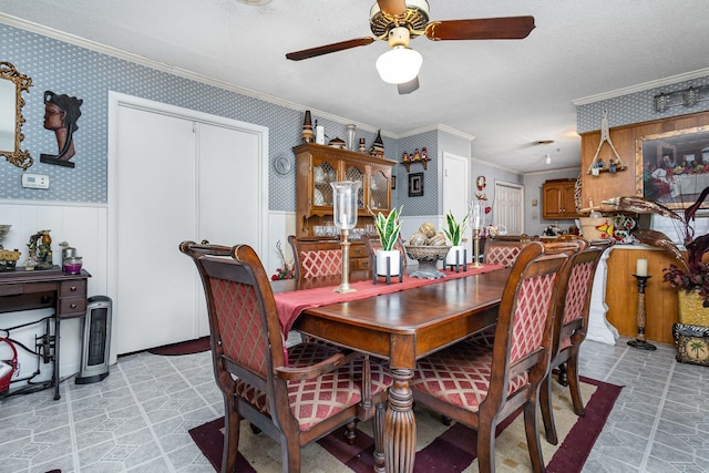 2530 Robin Ln, Garland, TX 75041 - dining space featuring crown molding, ceiling fan, a wainscoted wall, and wallpapered walls