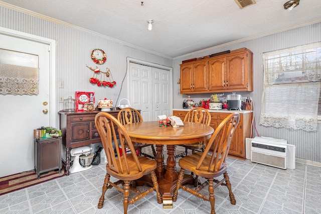 2530 Robin Ln, Garland, TX 75041 - dining room with ornamental molding, wallpapered walls, and a textured ceiling