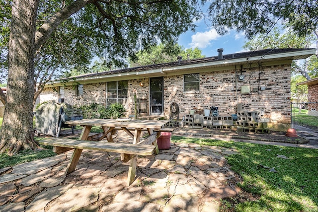 2530 Robin Ln, Garland, TX 75041 - rear view of property with a patio area, brick siding, and outdoor dining area