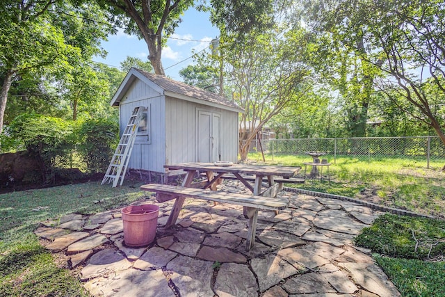 2530 Robin Ln, Garland, TX 75041 - fenced backyard featuring outdoor dining space, a patio, and a storage unit