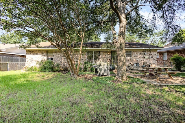 2530 Robin Ln, Garland, TX 75041 - back of property with brick siding and a patio area