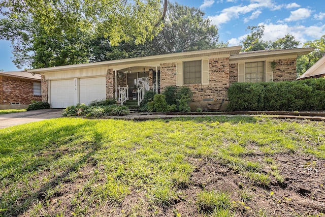 2530 Robin Ln, Garland, TX 75041 - view of front of property with brick siding, a garage, driveway, and a front yard