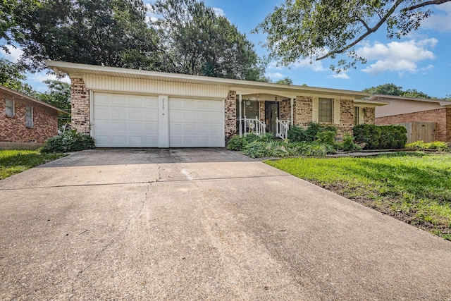2530 Robin Ln, Garland, TX 75041 - view of front of property with a garage, brick siding, driveway, and covered porch