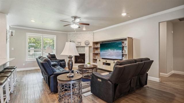 1530 Petaluma Dr, Rockwall, TX 75087 - living area featuring ceiling fan, a fireplace, wood finished floors, baseboards, and ornamental molding