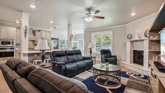 1530 Petaluma Dr, Rockwall, TX 75087 - living room with ceiling fan, light wood finished floors, crown molding, a fireplace, and recessed lighting