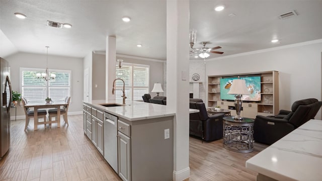 1530 Petaluma Dr, Rockwall, TX 75087 - kitchen with open floor plan, a chandelier, ceiling fan, light wood finished floors, and appliances with stainless steel finishes