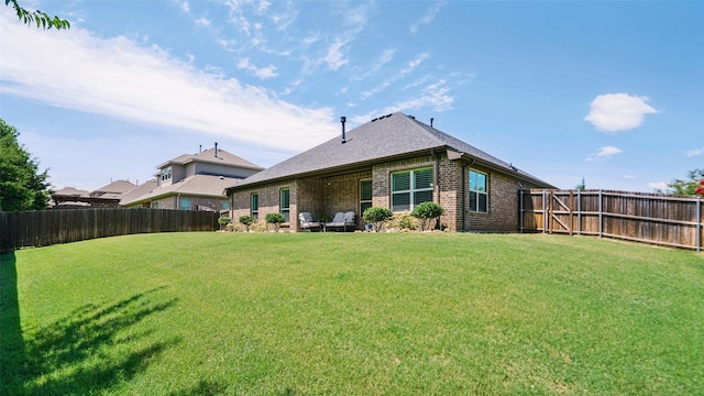 1530 Petaluma Dr, Rockwall, TX 75087 - back of property featuring a fenced backyard, brick siding, and roof with shingles