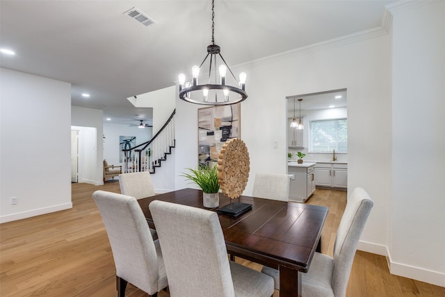 5031 Enclave Ct, Mckinney, TX 75072 - dining space featuring stairs, a chandelier, baseboards, light wood finished floors, and ornamental molding