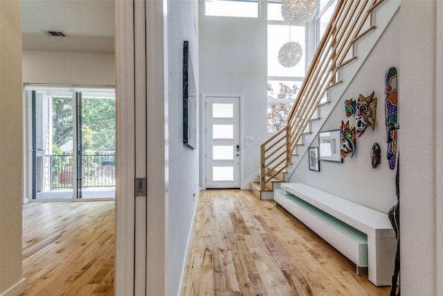 1328 Madeline Pl Unit B, Fort Worth, TX 76107 - entryway featuring light wood finished floors, stairway, and a chandelier
