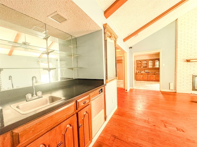 2414 St Gregory St, Arlington, TX 76013 - indoor wet bar with light wood-type flooring and a textured ceiling