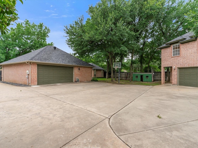 9120 Timber Oaks Dr, Fort Worth, TX 76179 - view of side of home featuring brick siding, a shingled roof, and driveway