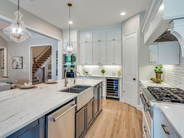 8542 Gerbera Daisy Rd, Frisco, TX 75035 - kitchen featuring wine cooler, stainless steel appliances, backsplash, decorative light fixtures, and recessed lighting