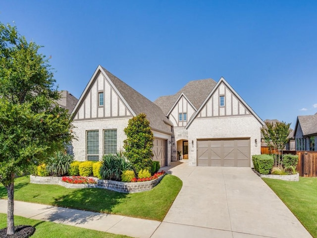 8542 Gerbera Daisy Rd, Frisco, TX 75035 - tudor home with driveway, an attached garage, brick siding, and stone siding