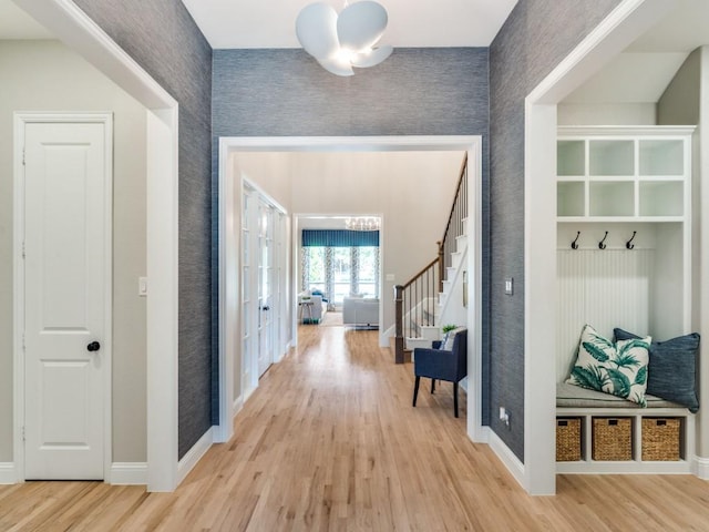 8542 Gerbera Daisy Rd, Frisco, TX 75035 - mudroom featuring wallpapered walls, light wood-style flooring, and a chandelier