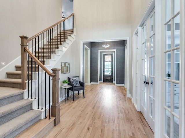 8542 Gerbera Daisy Rd, Frisco, TX 75035 - foyer with a towering ceiling, french doors, stairway, and wood finished floors