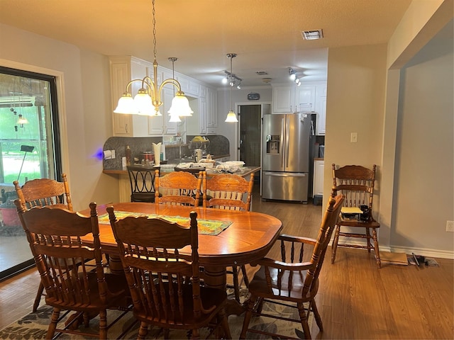 720 Robindale, Fairfield, TX 75840 - dining space with wood finished floors and a chandelier