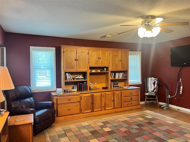 720 Robindale, Fairfield, TX 75840 - sitting room with ceiling fan, a textured ceiling, baseboards, and light wood-style floors