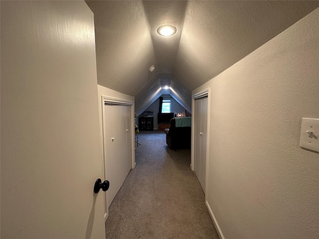 819 Beech St, Bonham, TX 75418 - hall featuring lofted ceiling, carpet, and a textured ceiling