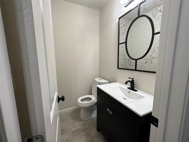819 Beech St, Bonham, TX 75418 - half bathroom featuring toilet, vanity, and baseboards