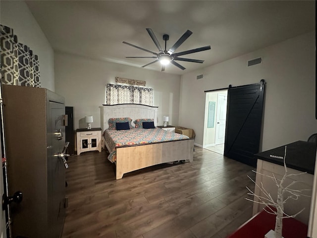 819 Beech St, Bonham, TX 75418 - bedroom with a barn door, dark wood-style flooring, and a ceiling fan
