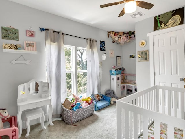 401 S 2nd St, Wortham, TX 76693 - bedroom featuring a crib, carpet, and a ceiling fan