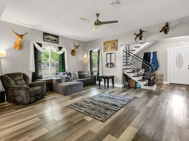 401 S 2nd St, Wortham, TX 76693 - living room featuring stairs, a ceiling fan, and wood finished floors