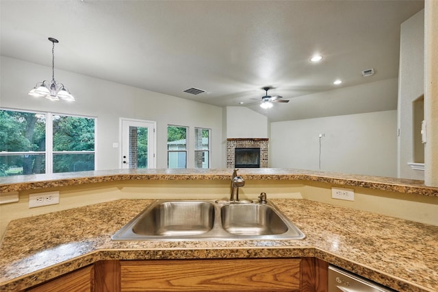 8109 County Road 804, Burleson, TX 76028 - kitchen with ceiling fan, a fireplace, stainless steel dishwasher, hanging light fixtures, and vaulted ceiling