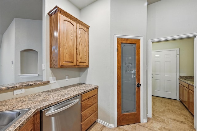 8109 County Road 804, Burleson, TX 76028 - kitchen with dishwasher, brown cabinets, and light tile patterned flooring