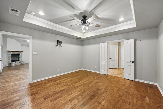 8109 County Road 804, Burleson, TX 76028 - unfurnished room featuring a tray ceiling, crown molding, a ceiling fan, hardwood / wood-style floors, and a smoke detector