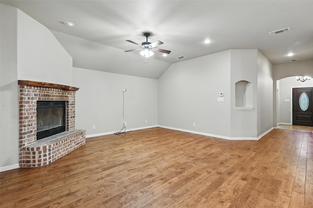 8109 County Road 804, Burleson, TX 76028 - unfurnished living room with wood finished floors, ceiling fan, lofted ceiling, recessed lighting, and a brick fireplace
