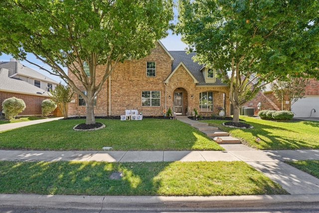 4304 Wildbriar Ln, Mansfield, TX 76063 - traditional-style house featuring a front lawn, cooling unit, and brick siding