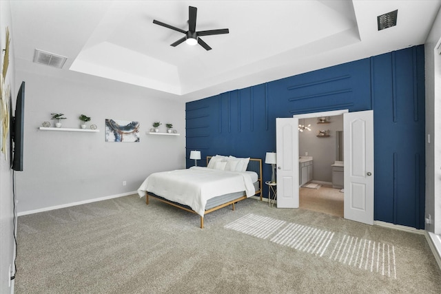 4304 Wildbriar Ln, Mansfield, TX 76063 - bedroom featuring a raised ceiling, light carpet, ceiling fan, and ensuite bath