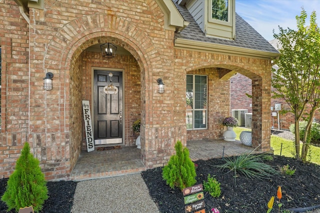 4304 Wildbriar Ln, Mansfield, TX 76063 - property entrance with brick siding, a shingled roof, and covered porch