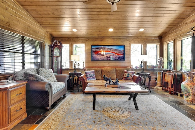 161 Cheyenne Dr, Nocona, TX 76255 - living room with vaulted ceiling, plenty of natural light, wood ceiling, wood walls, and stone tile floors