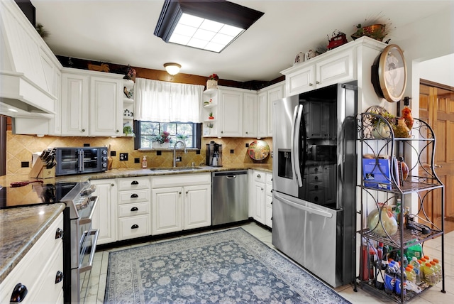 161 Cheyenne Dr, Nocona, TX 76255 - kitchen with appliances with stainless steel finishes, a sink, open shelves, custom range hood, and white cabinetry