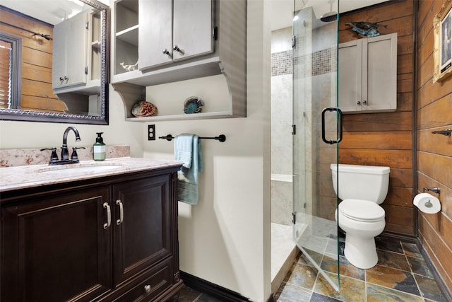 161 Cheyenne Dr, Nocona, TX 76255 - bathroom featuring stone finish floors, toilet, vanity, a shower stall, and wooden walls