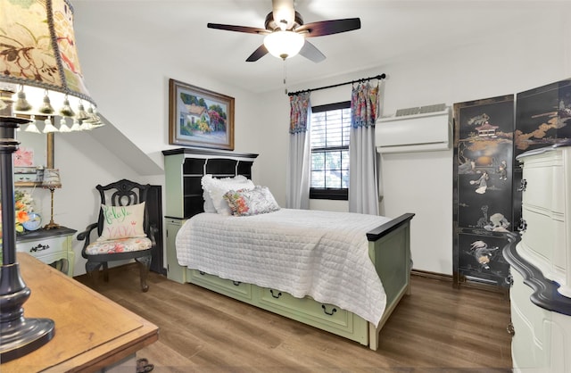 161 Cheyenne Dr, Nocona, TX 76255 - bedroom featuring wood finished floors, a wall unit AC, and a ceiling fan