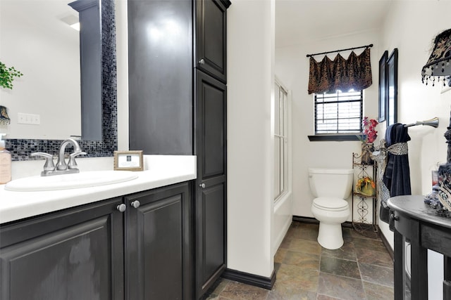 161 Cheyenne Dr, Nocona, TX 76255 - full bathroom with stone finish floors, toilet, bathtub / shower combination, baseboards, and vanity