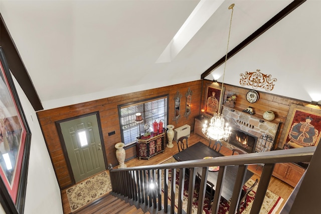 161 Cheyenne Dr, Nocona, TX 76255 - foyer entrance with wooden walls, lofted ceiling, wood finished floors, a skylight, and a fireplace