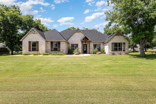 3011 Skyhawk Dr, Granbury, TX 76049 - view of front of property with stone siding, a front lawn, and a shingled roof