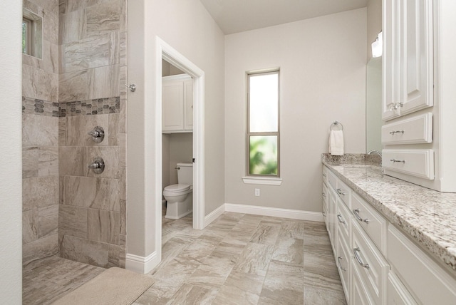 3011 Skyhawk Dr, Granbury, TX 76049 - full bath with toilet, walk in shower, vanity, baseboards, and marble look tile flooring
