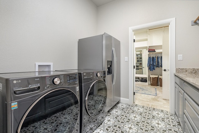 3011 Skyhawk Dr, Granbury, TX 76049 - laundry area with washing machine and dryer, cabinet space, light tile patterned floors, and baseboards