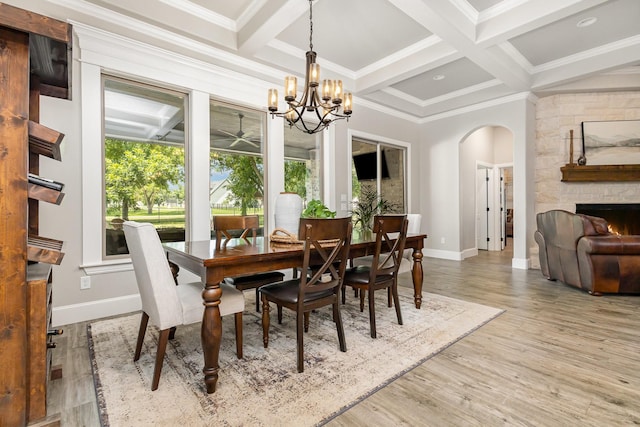 3011 Skyhawk Dr, Granbury, TX 76049 - dining area featuring arched walkways, baseboards, a fireplace, beam ceiling, and a chandelier