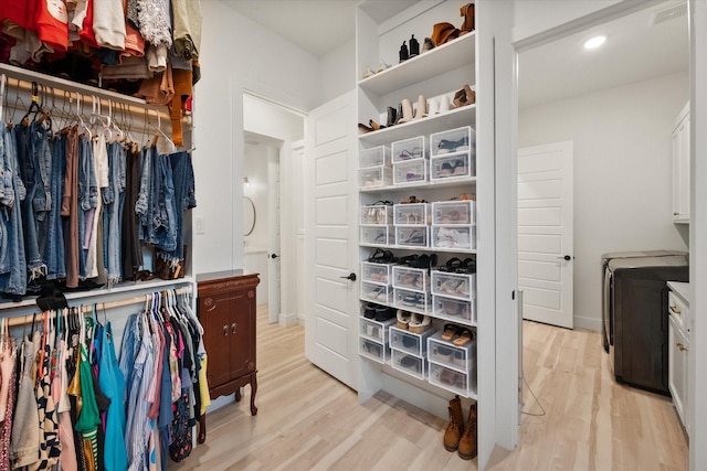 1911 Ozro Rd, Venus, TX 76084 - walk in closet with light wood-style floors and washing machine and clothes dryer