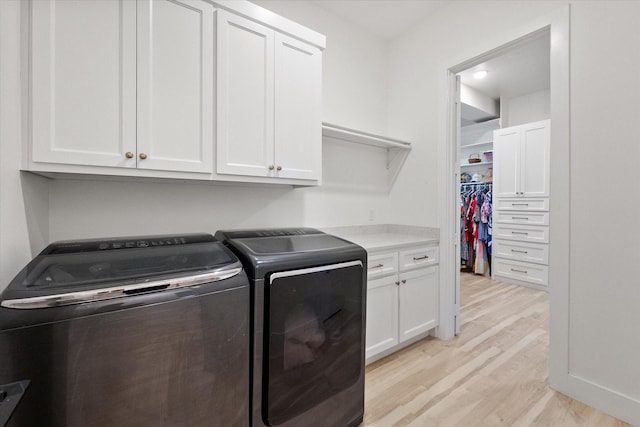 1911 Ozro Rd, Venus, TX 76084 - laundry area featuring cabinet space, light wood-style floors, and separate washer and dryer