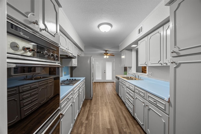 410 S Walnut Grove Rd, Midlothian, TX 76065 - kitchen with oven, ceiling fan, a sink, wood finished floors, and dishwasher