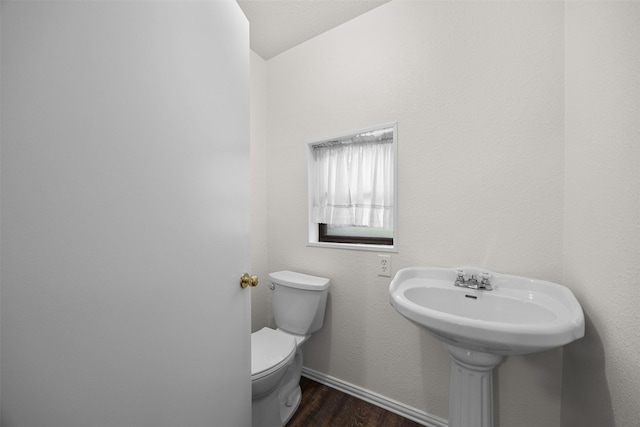 410 S Walnut Grove Rd, Midlothian, TX 76065 - half bathroom with wood finished floors, toilet, and baseboards