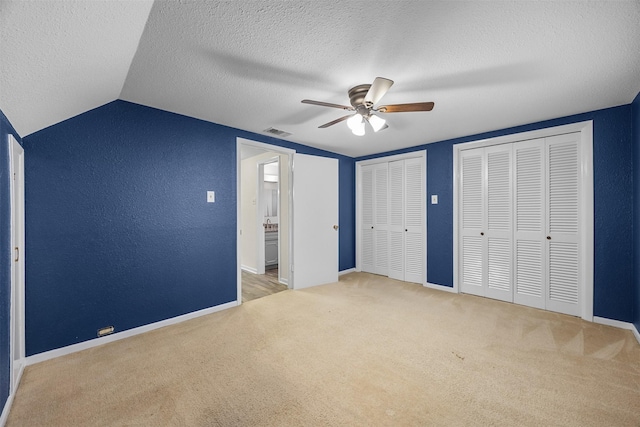 410 S Walnut Grove Rd, Midlothian, TX 76065 - unfurnished bedroom featuring carpet flooring, multiple closets, baseboards, vaulted ceiling, and a textured ceiling