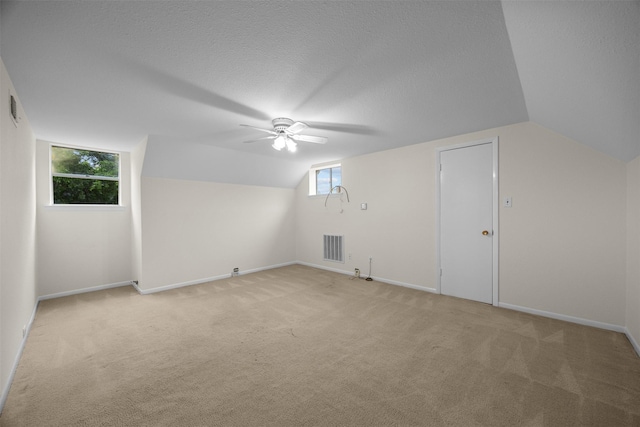 410 S Walnut Grove Rd, Midlothian, TX 76065 - additional living space with ceiling fan, lofted ceiling, light colored carpet, baseboards, and a textured ceiling